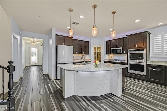 3096 Beaux Art Ave, Henderson, NV 89044 - kitchen with appliances with stainless steel finishes, a sink, backsplash, recessed lighting, and dark brown cabinetry