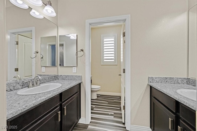 3096 Beaux Art Ave, Henderson, NV 89044 - full bath featuring baseboards, vanity, toilet, and wood finished floors