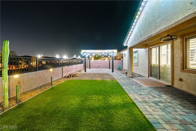 3096 Beaux Art Ave, Henderson, NV 89044 - yard at night featuring a patio area and a pergola