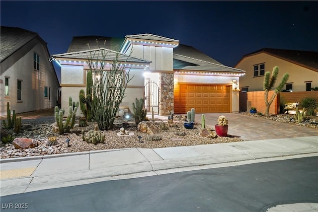 3096 Beaux Art Ave, Henderson, NV 89044 - view of front of home with a garage, driveway, stucco siding, and stone siding