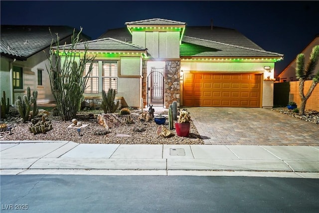 3096 Beaux Art Ave, Henderson, NV 89044 - view of front of home with a garage, driveway, stone siding, and stucco siding