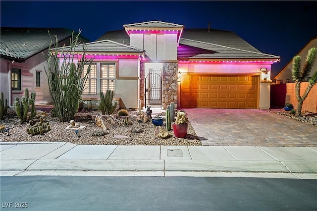 3096 Beaux Art Ave, Henderson, NV 89044 - view of front of home featuring an attached garage, driveway, and stone siding