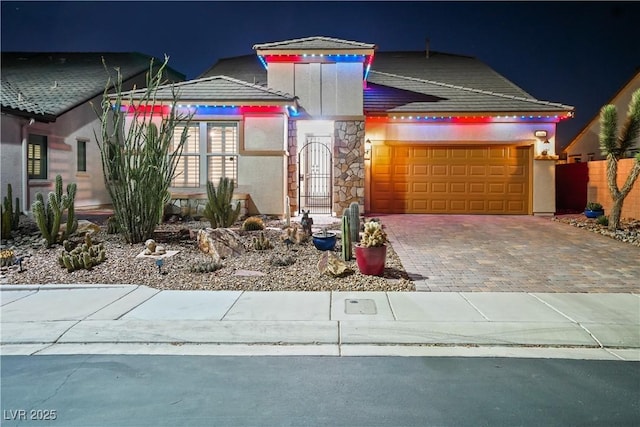 3096 Beaux Art Ave, Henderson, NV 89044 - view of front of property with an attached garage, driveway, stone siding, and stucco siding