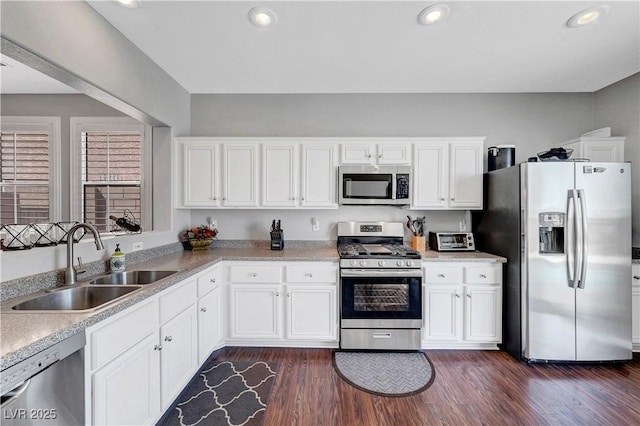 4020 Driscoll Mountain St, Las Vegas, NV 89129 - kitchen featuring stainless steel appliances, a sink, dark wood-style flooring, white cabinetry, and recessed lighting