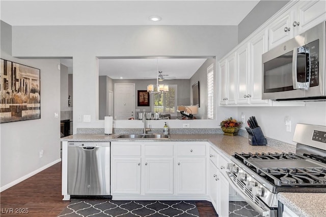 4020 Driscoll Mountain St, Las Vegas, NV 89129 - kitchen featuring stainless steel appliances, a sink, a chandelier, light countertops, and white cabinetry