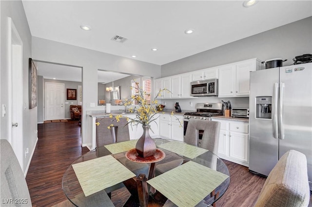 4020 Driscoll Mountain St, Las Vegas, NV 89129 - kitchen with stainless steel appliances, dark wood finished floors, light countertops, white cabinetry, and recessed lighting