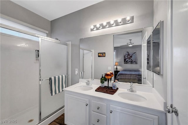 4020 Driscoll Mountain St, Las Vegas, NV 89129 - ensuite bathroom featuring a shower stall, double vanity, ceiling fan, and wood finished floors