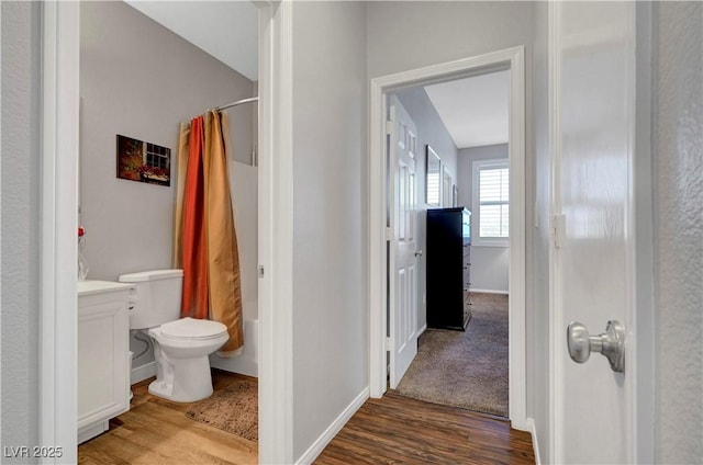 4020 Driscoll Mountain St, Las Vegas, NV 89129 - bathroom featuring wood finished floors, shower / bath combination with curtain, toilet, vanity, and baseboards