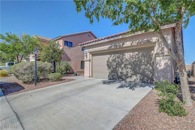 4020 Driscoll Mountain St, Las Vegas, NV 89129 - view of front facade with driveway, stucco siding, a garage, and a tiled roof