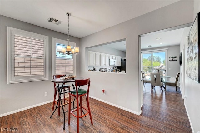 4020 Driscoll Mountain St, Las Vegas, NV 89129 - dining area with dark wood-style floors, a chandelier, and baseboards