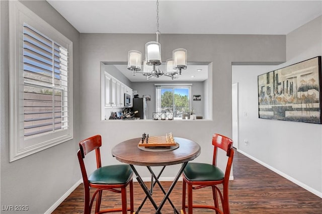 4020 Driscoll Mountain St, Las Vegas, NV 89129 - dining room featuring wood finished floors, a chandelier, and baseboards