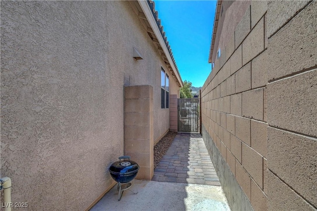 4020 Driscoll Mountain St, Las Vegas, NV 89129 - view of home's exterior featuring stucco siding and a gate
