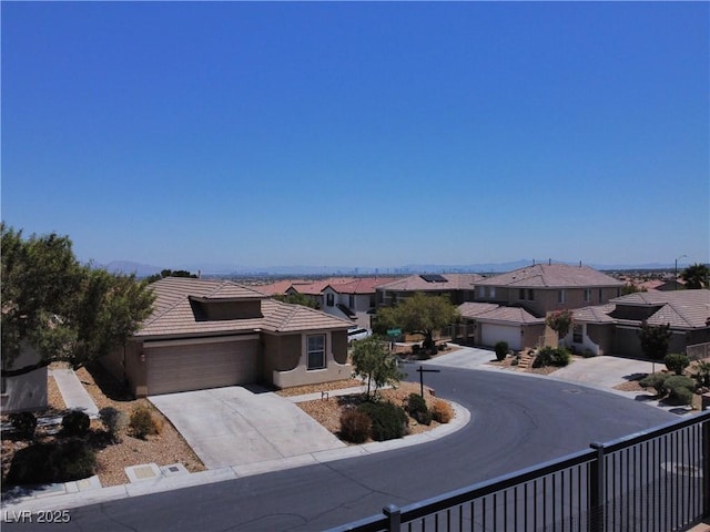 4020 Driscoll Mountain St, Las Vegas, NV 89129 - view of front of home with a residential view, a garage, concrete driveway, a tile roof, and stucco siding
