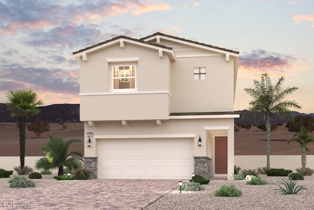 889 Arbor Spring St, Henderson, NV 89011 - view of front of home featuring stone siding, stucco siding, decorative driveway, and an attached garage