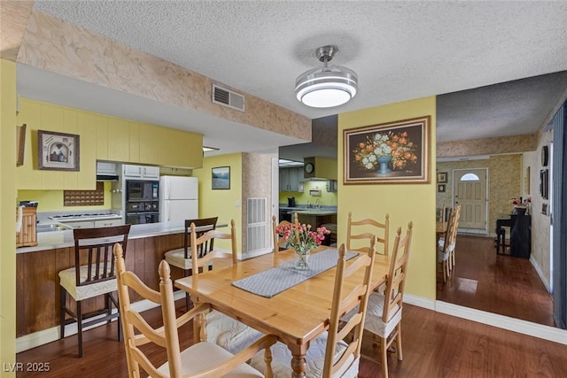 3815 Atlantis St, Las Vegas, NV 89121 - dining space with wood finished floors, baseboards, and a textured ceiling