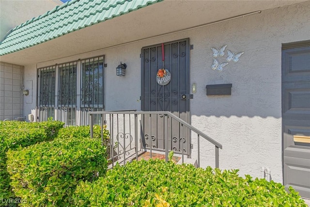 3815 Atlantis St, Las Vegas, NV 89121 - doorway to property with stucco siding and a tiled roof