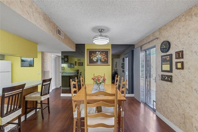 3815 Atlantis St, Las Vegas, NV 89121 - dining room featuring wood finished floors, a textured ceiling, baseboards, and a textured wall