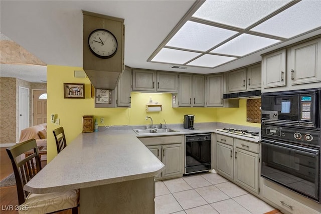 3815 Atlantis St, Las Vegas, NV 89121 - kitchen featuring black appliances, a sink, a peninsula, light countertops, and light tile patterned floors