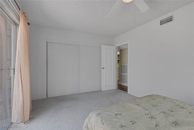 3815 Atlantis St, Las Vegas, NV 89121 - unfurnished bedroom featuring carpet, a textured ceiling, a ceiling fan, and a closet
