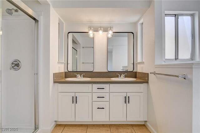 6521 Faith Peak Dr, Las Vegas, NV 89108 - bathroom with a stall shower, double vanity, tile patterned flooring, and baseboards