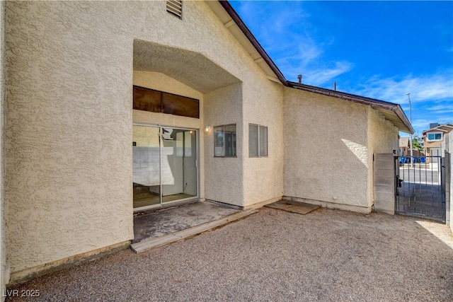 6521 Faith Peak Dr, Las Vegas, NV 89108 - view of home's exterior featuring stucco siding, a gate, and a patio