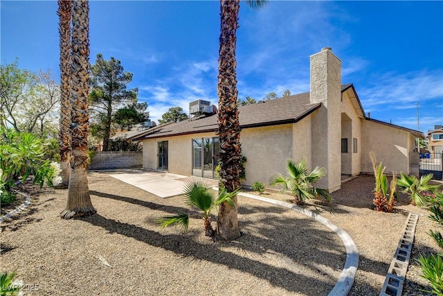 6521 Faith Peak Dr, Las Vegas, NV 89108 - rear view of house with stucco siding and a patio area