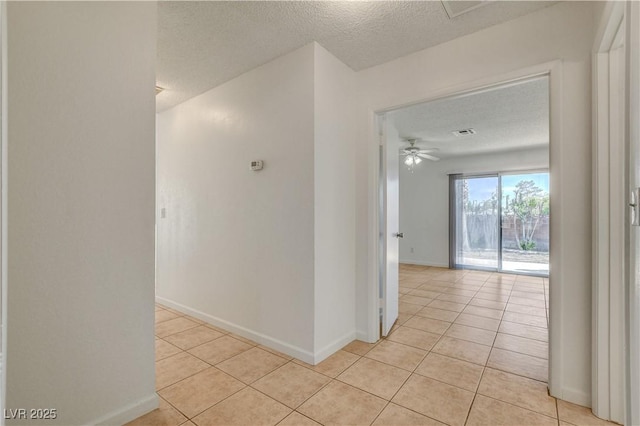 6521 Faith Peak Dr, Las Vegas, NV 89108 - hall with light tile patterned flooring, a textured ceiling, and baseboards