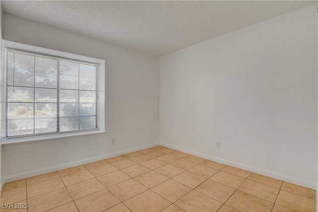 6521 Faith Peak Dr, Las Vegas, NV 89108 - spare room with plenty of natural light, light tile patterned floors, a textured ceiling, and baseboards
