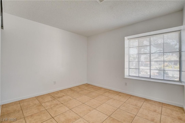 6521 Faith Peak Dr, Las Vegas, NV 89108 - empty room featuring a textured ceiling, light tile patterned flooring, and baseboards