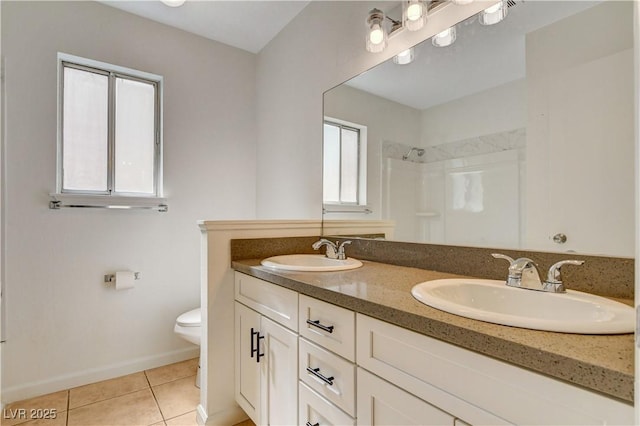 6521 Faith Peak Dr, Las Vegas, NV 89108 - bathroom with a shower, toilet, tile patterned flooring, double vanity, and baseboards
