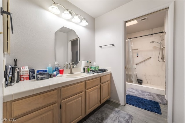 2851 S Valley View Blvd Unit 1071, Las Vegas, NV 89102 - bathroom with vanity, a stall shower, and wood finished floors