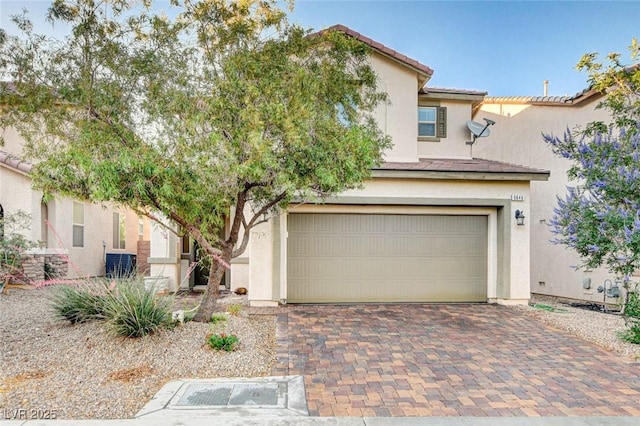 9846 Sunriver Meadows Ave, Las Vegas, NV 89148 - view of front of house featuring a garage, stucco siding, decorative driveway, central AC, and a tiled roof
