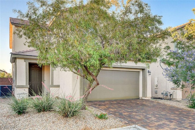 9846 Sunriver Meadows Ave, Las Vegas, NV 89148 - view of property hidden behind natural elements featuring decorative driveway and stucco siding