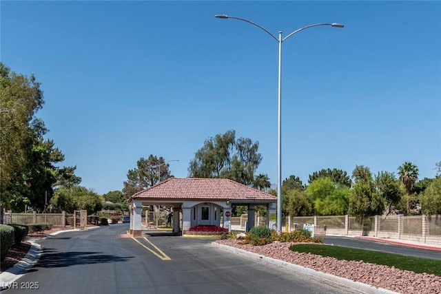 4904 Wiltondale Way, Las Vegas, NV 89130 - view of asphalt street featuring street lights, curbs, and a gated entry