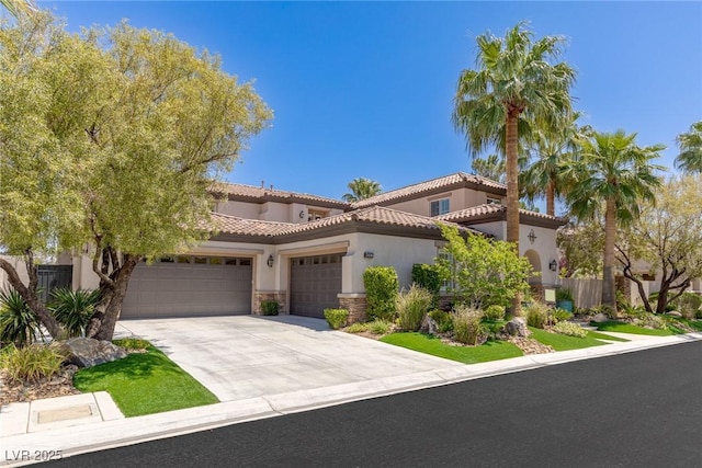 2436 Grassy Spring Pl, Las Vegas, NV 89135 - mediterranean / spanish house featuring an attached garage, concrete driveway, stucco siding, a tiled roof, and stone siding