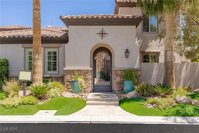 2436 Grassy Spring Pl, Las Vegas, NV 89135 - doorway to property with a tiled roof, stucco siding, and stone siding