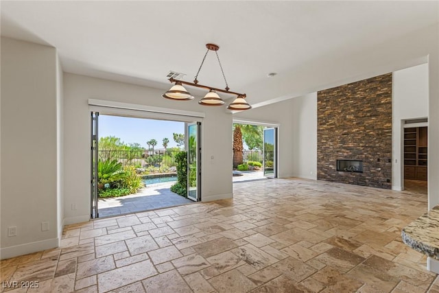 2436 Grassy Spring Pl, Las Vegas, NV 89135 - unfurnished living room featuring stone tile floors and a fireplace