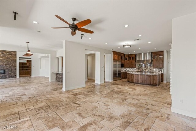 2436 Grassy Spring Pl, Las Vegas, NV 89135 - kitchen featuring open floor plan, wall chimney range hood, built in fridge, tasteful backsplash, and stone tile floors