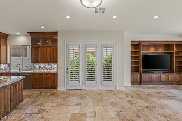 2436 Grassy Spring Pl, Las Vegas, NV 89135 - kitchen featuring stainless steel dishwasher, light stone counters, recessed lighting, tasteful backsplash, and stone tile flooring
