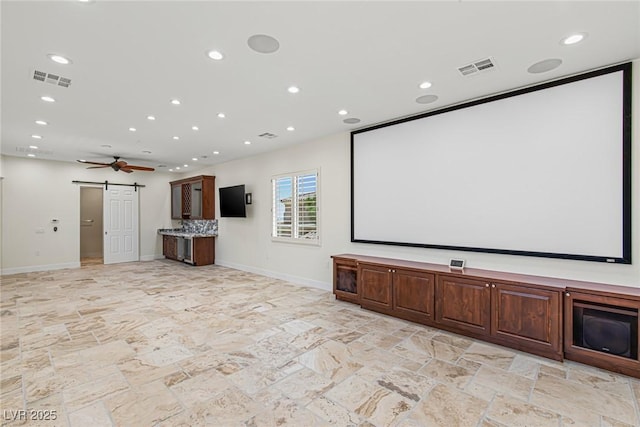2436 Grassy Spring Pl, Las Vegas, NV 89135 - cinema room featuring a barn door, stone tile floors, recessed lighting, and ceiling fan