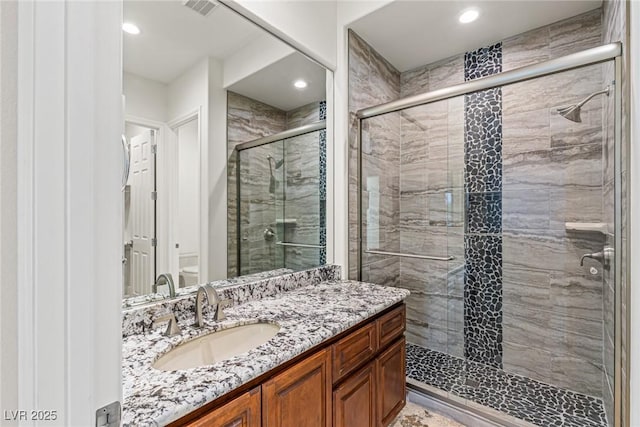 2436 Grassy Spring Pl, Las Vegas, NV 89135 - bathroom with vanity, a stall shower, and recessed lighting