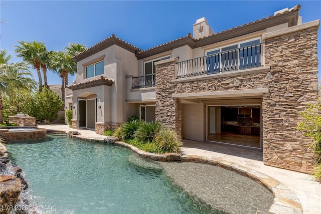 2436 Grassy Spring Pl, Las Vegas, NV 89135 - rear view of property with stone siding, a balcony, a chimney, and stucco siding