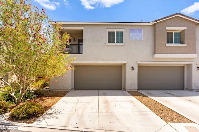 2495 Sunflower Days Ave Unit 2052, North Las Vegas, NV 89031 - townhome / multi-family property with an attached garage, stucco siding, and driveway