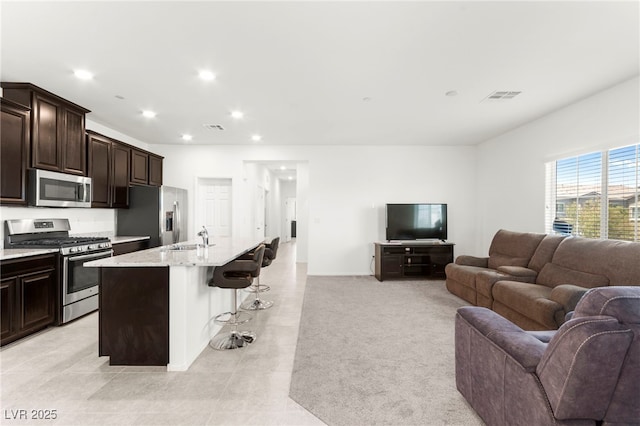 2495 Sunflower Days Ave Unit 2052, North Las Vegas, NV 89031 - kitchen featuring appliances with stainless steel finishes, open floor plan, a sink, a breakfast bar, and recessed lighting