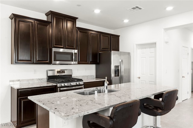 2495 Sunflower Days Ave Unit 2052, North Las Vegas, NV 89031 - kitchen featuring stainless steel appliances, a sink, a kitchen breakfast bar, light stone counters, and recessed lighting