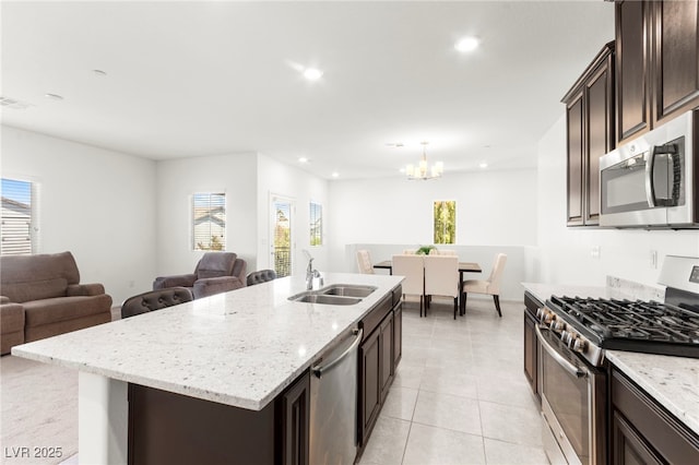2495 Sunflower Days Ave Unit 2052, North Las Vegas, NV 89031 - kitchen featuring stainless steel appliances, a sink, open floor plan, dark brown cabinetry, and recessed lighting