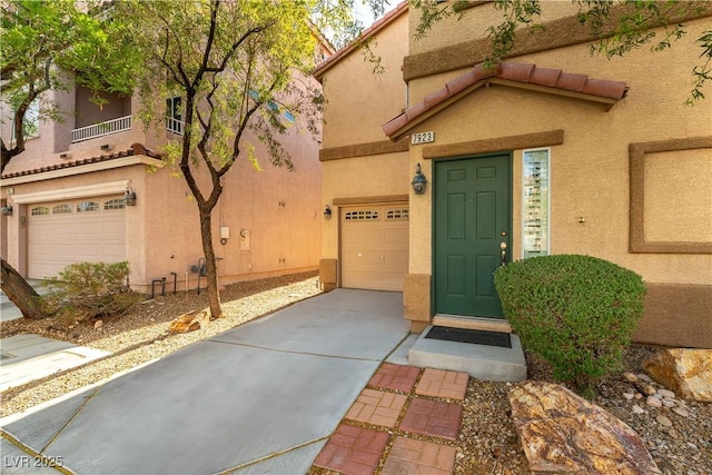 7923 Homer Ct, Las Vegas, NV 89139 - property entrance with concrete driveway, stucco siding, and a garage