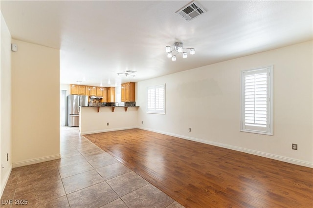 7923 Homer Ct, Las Vegas, NV 89139 - unfurnished living room with baseboards and light tile patterned floors