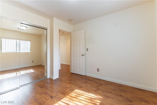 7923 Homer Ct, Las Vegas, NV 89139 - unfurnished bedroom featuring wood finished floors, a closet, and baseboards