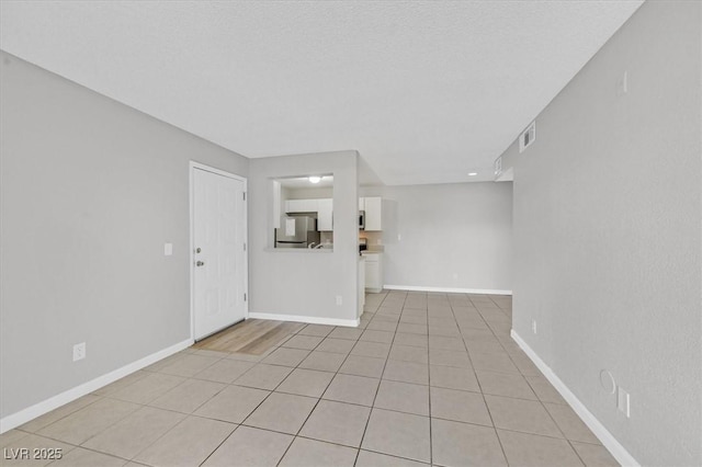 230 Mission Newport Ln Unit 104, Las Vegas, NV 89107 - empty room featuring baseboards and light tile patterned floors